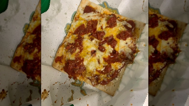 Mirrored image of Flatizza on paper in green dish