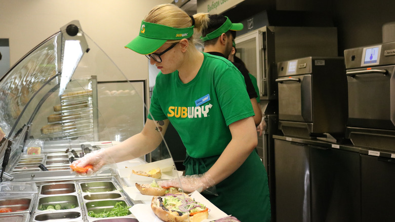 subway employee making sandwich