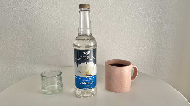 bottle of Syruvia sugar-free vanilla syrup with coffee
