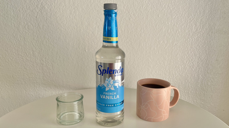 splenda syrup bottle with a cup of coffee