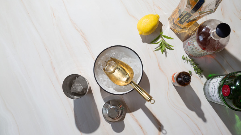 Shaker with ice next to a bowl