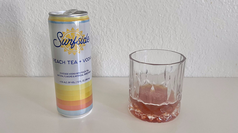 Peach Tea + Vodka can with a glass