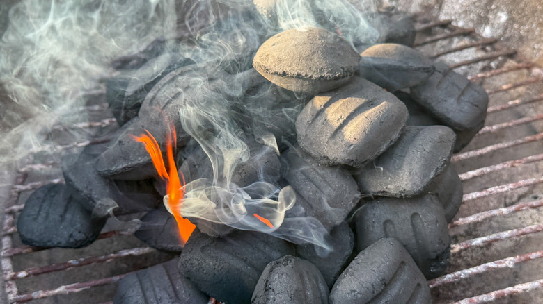 Charcoal being lit on a grill