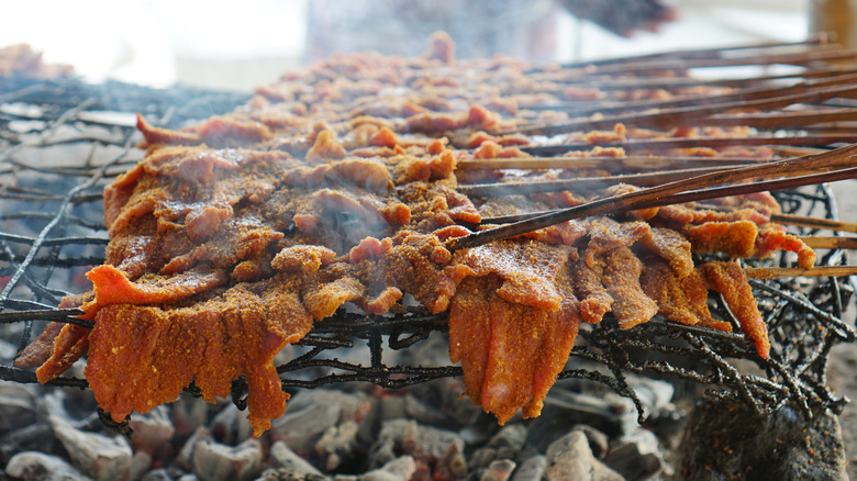 Nigerian suya cooking on a grill