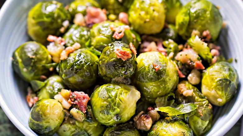 Close-up of Brussels sprouts with bacon bits in a bowl