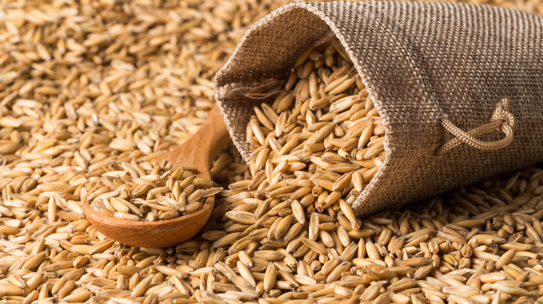 Oat groats spilling from bag