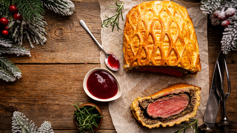 Overhead view of classic beef Wellington on a table with holiday decor