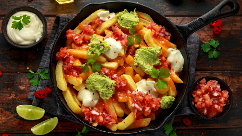 skillet of potatoes with nacho toppings