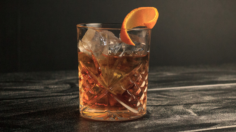 classic old fashioned cocktail with orange garnish