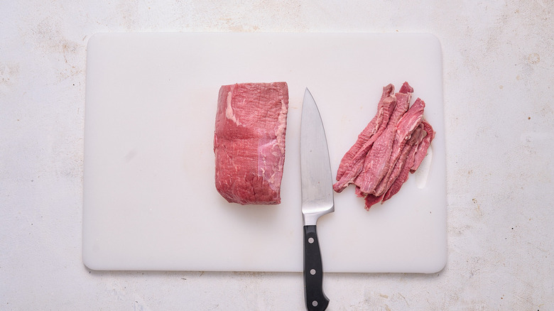 slicing beef into thin strips