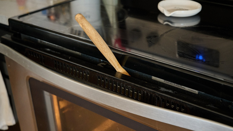 propping open oven door with a spoon