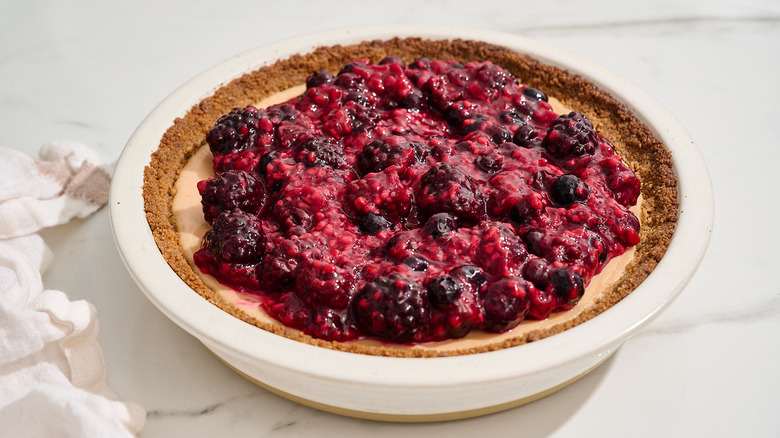 key lime pie topped with berry compote