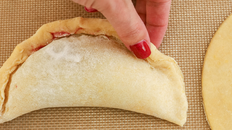 empanadas being sealed closed