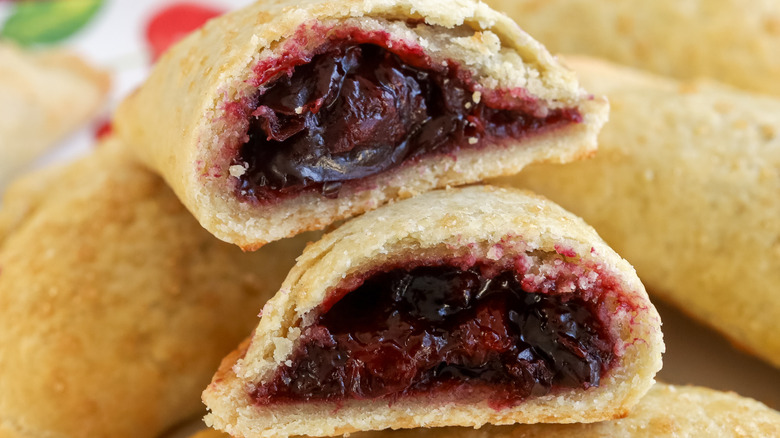 close up of a cut open sweet, gooey cherry pie empanadas