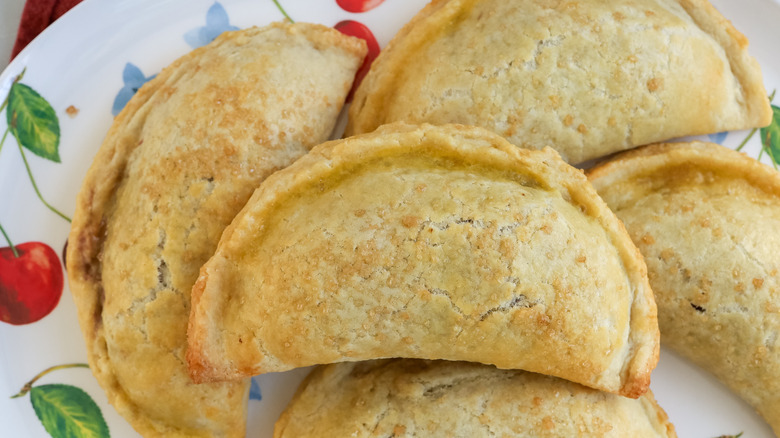 a plate filled with sweet, gooey cherry pie empanadas
