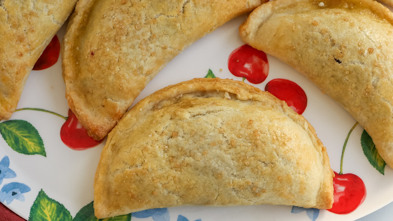 close up of a cherry pie empanada on a plate