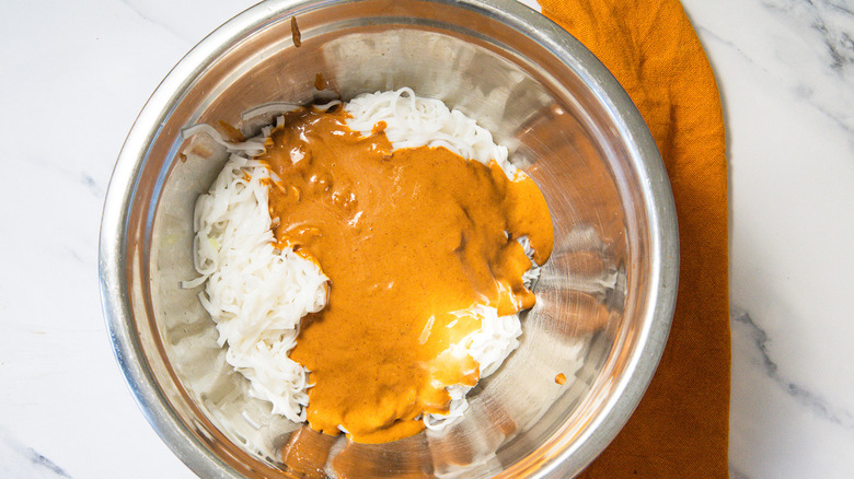 Noodles and peanut sauce in bowl
