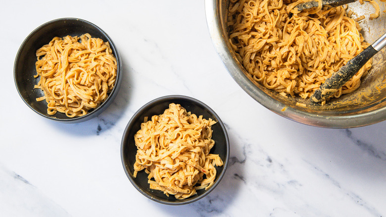 Two bowls of peanut noodles