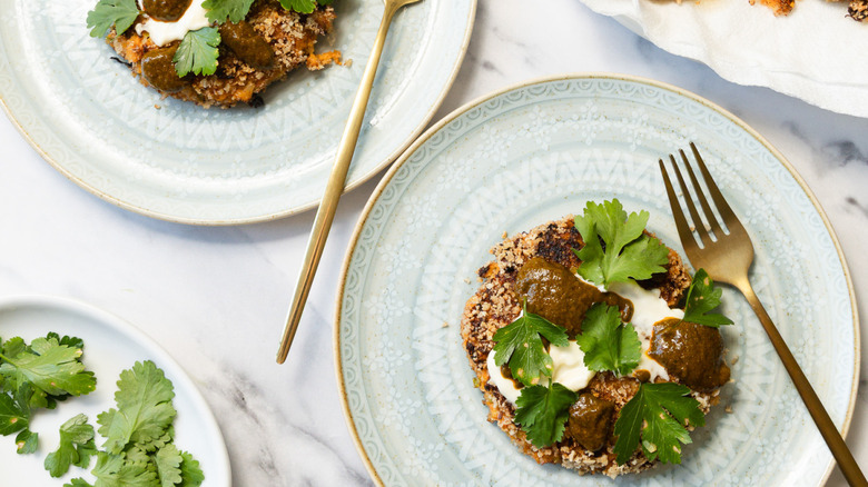 Two sweet potato crab cakes with mayonnaise and chermoula