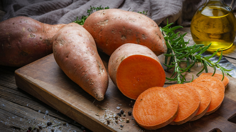 Three whole sweet potatoes and one cut into round slices.