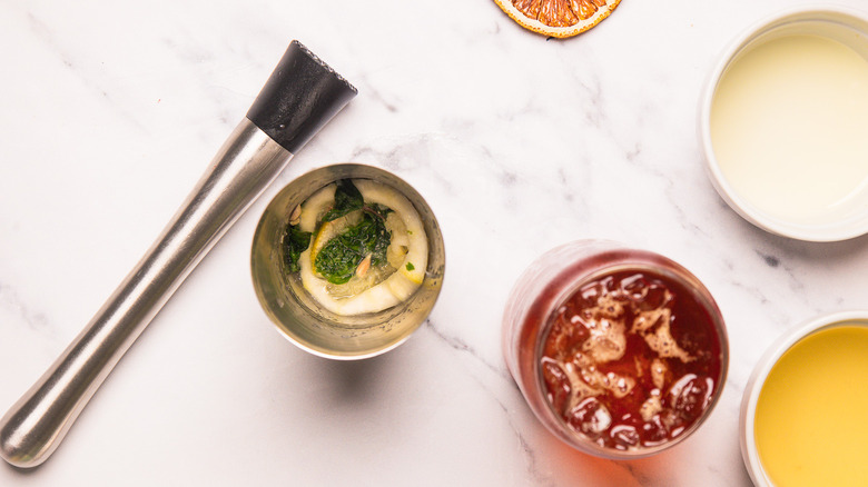 Muddled mint and lemon in shaker