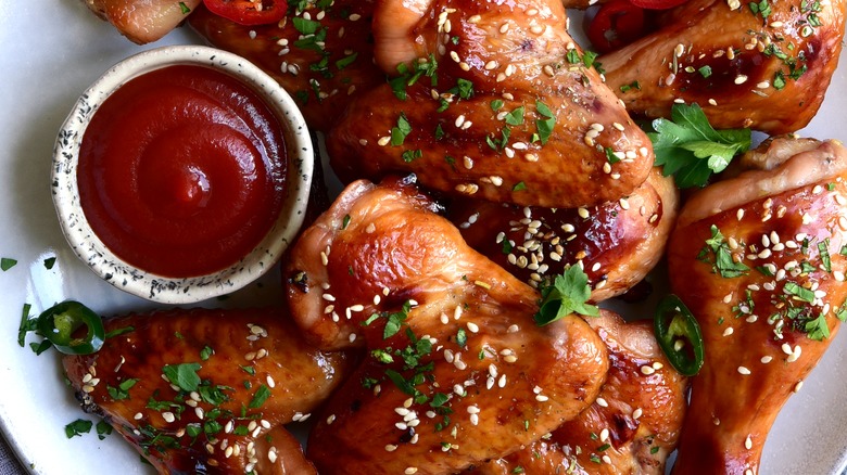 Top-down view of a ketchup dish with honey chicken wings