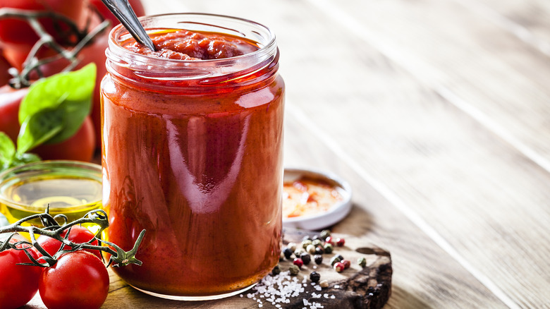 A glass jar of tomato sauce