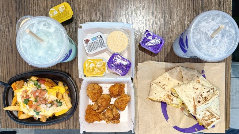 An assortment of new Taco Bell menu items, including Dirty Sips drinks, Diablo Dusted Chicken Nuggets, Zab's Diablo Ranch Fried, and a Double Triple Crunchwrap