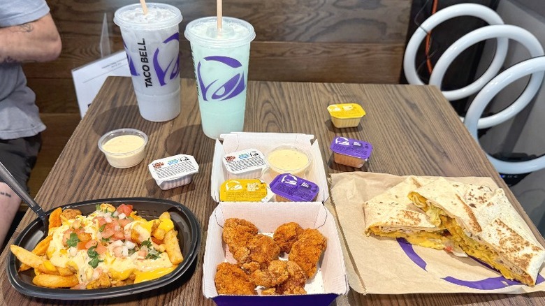 An assortment of new Taco Bell menu items, including Dirty Sips drinks, Diablo Dusted Chicken Nuggets, Zab's Diablo Ranch Fried, and a Double Triple Crunchwrap