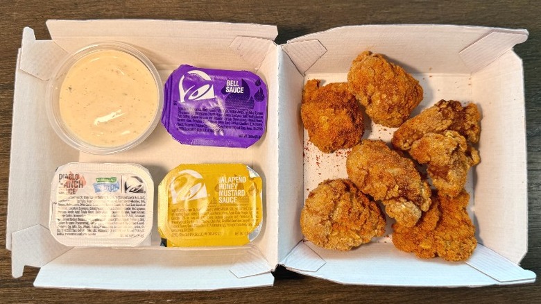Taco Bell Diablo Dusted Crispy Chicken Nuggets in a container with sauces