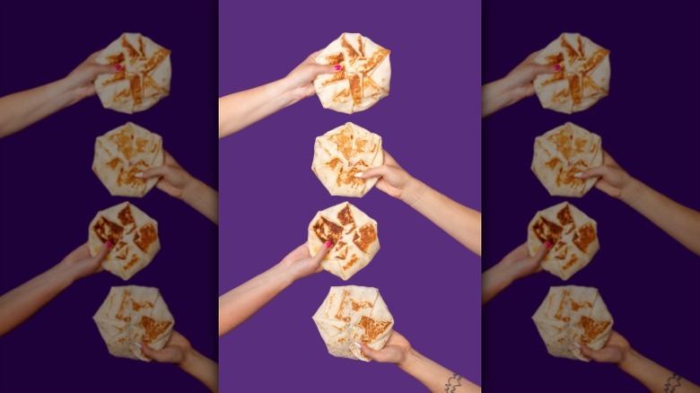 Hands holding Crunchwrap Supremes