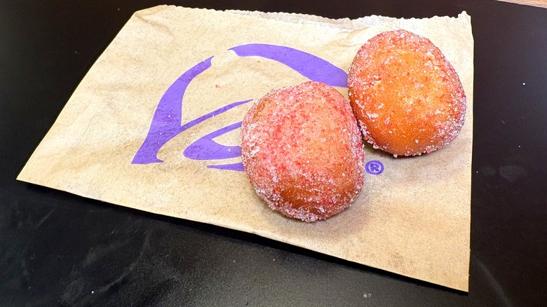 Two Strawberry Cinnabon Delights on top of their bag