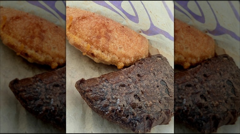 Two empanadas on a piece of paper