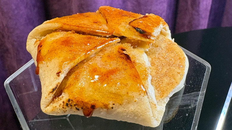 A Crème Brûlée Crunchwrap on a pedestal