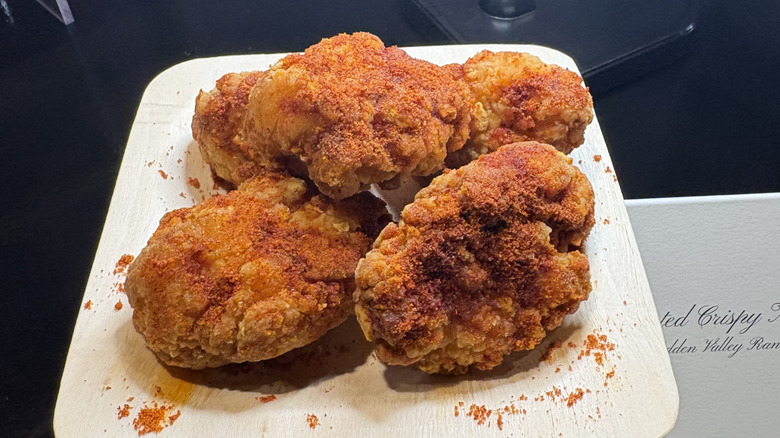 Five Diablo Crusted Crispy Chicken Nuggets stacked on a plate