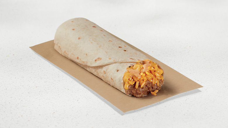 Taco Bell cheesy rice and bean burrito on brown wrapper
