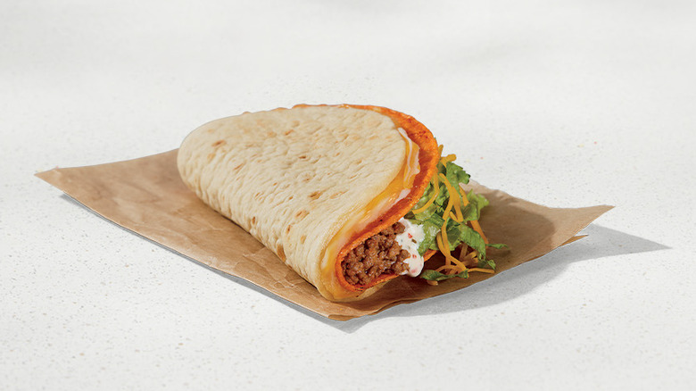 Taco Bell Doritos Cheesy Gordita Crunch on beige background