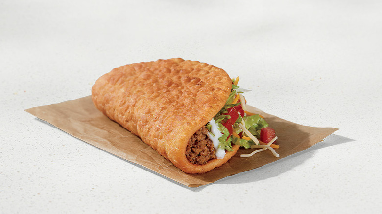 Taco Bell Chalupa supreme on beige background
