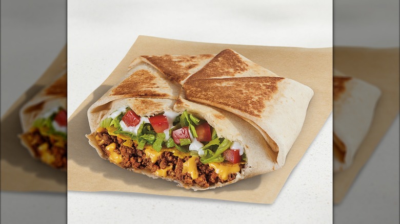 Crunchwrap Supreme close-up on a paper wrapper
