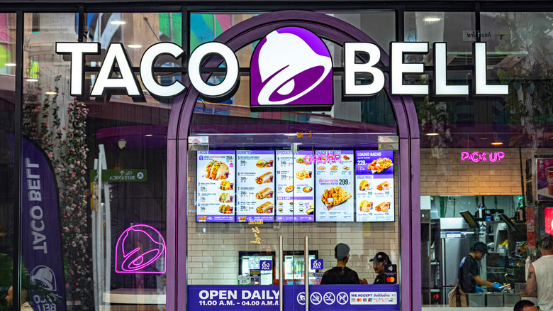 Taco Bell menu with a view of the outdoor sign, customers, and employees