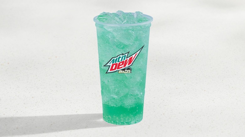 Large cup of Mtn Dew Baja Blast with a shadow on a white background