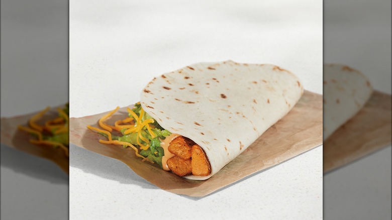 Spicy potato soft taco on its side