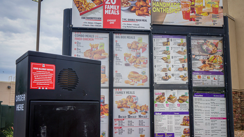 sign at Taco Bell with menu and deals