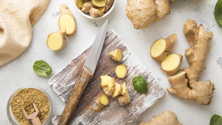 Fresh ginger chopped on board