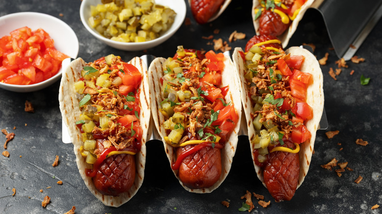 Hot dog in a tortilla with toppings