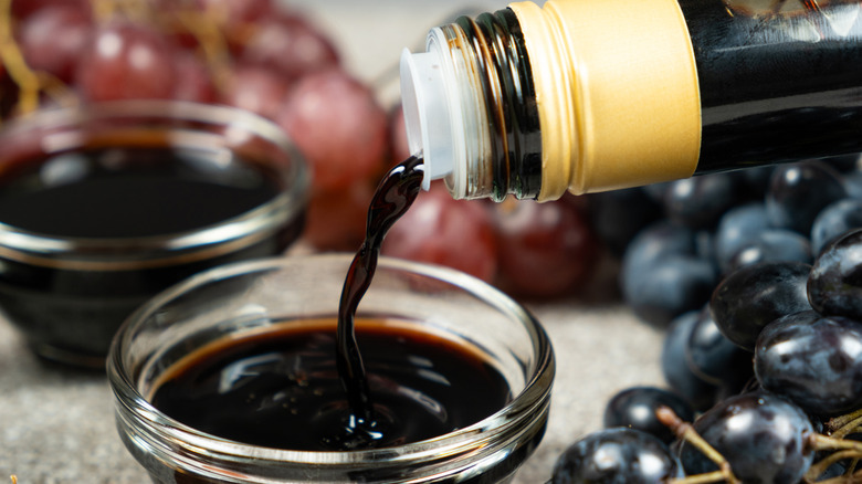 balsamic vinegar is poured into a glass bowl