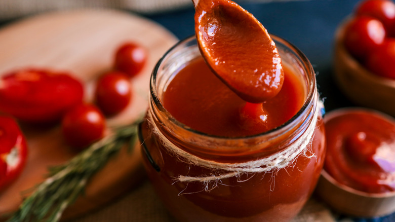 tomato sauce stirred with a wooden spoon