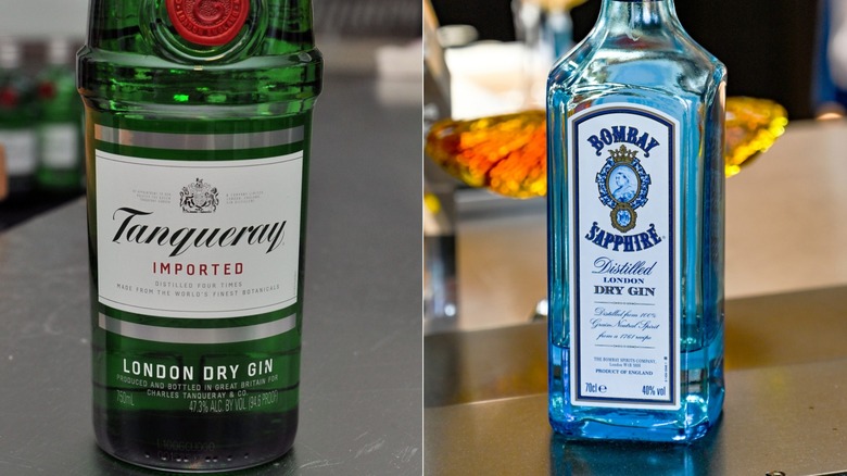 Two rows of multicolored liquor bottles on a shelf with ice in the foreground. Various gins, including Tanqueray and Bombay, are visible.