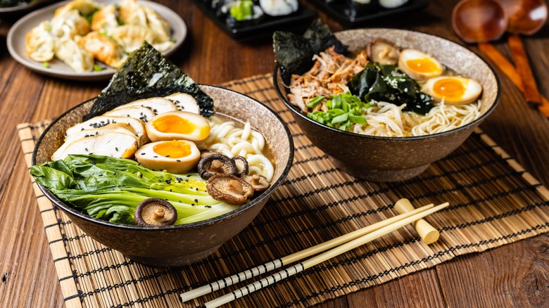 two bowls of ramen with different toppings