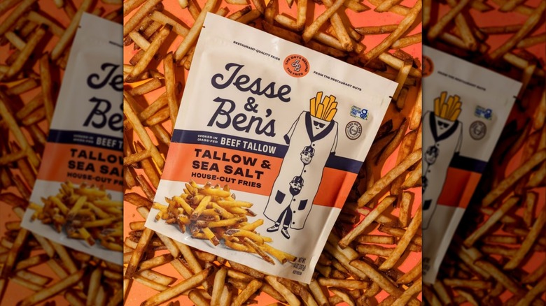 Jesse & Ben's Tallow & Sea Salt House-Cut Fries bag surrounded by french Fries